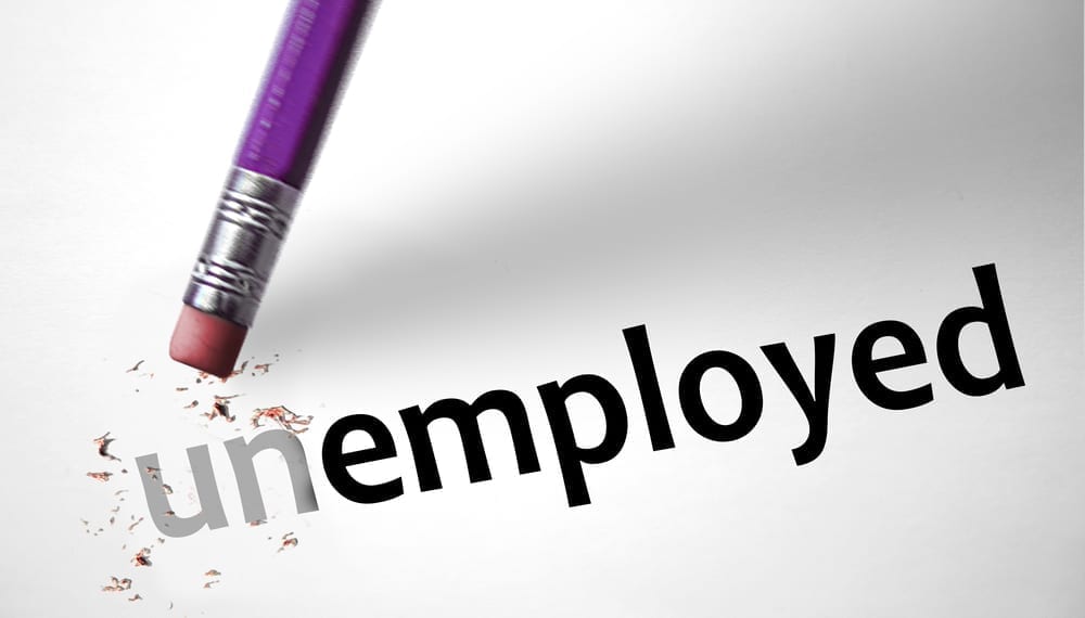 The words "Unemployed" on a piece of paper, with the "un" section erased