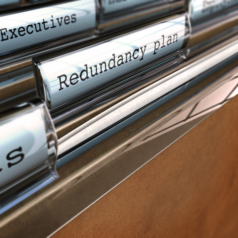 A draw of paper folders, with the focus on a label reading "Redundancy plan"