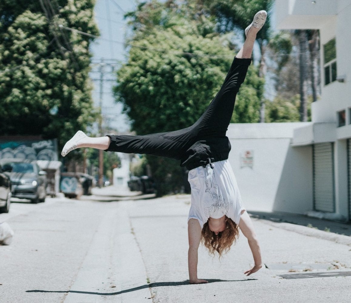 A person mid-way through performing a cartwheel manoeuvre