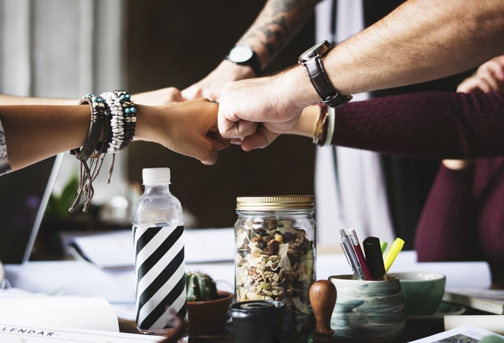 A group of people doing a fist bump