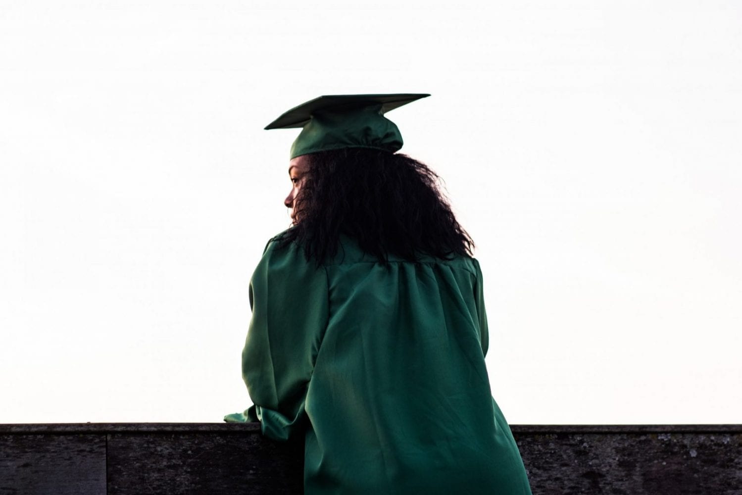 A graduate looking out to a white vista