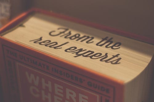 A book with the words "From the real experts" on the top edges of the pages