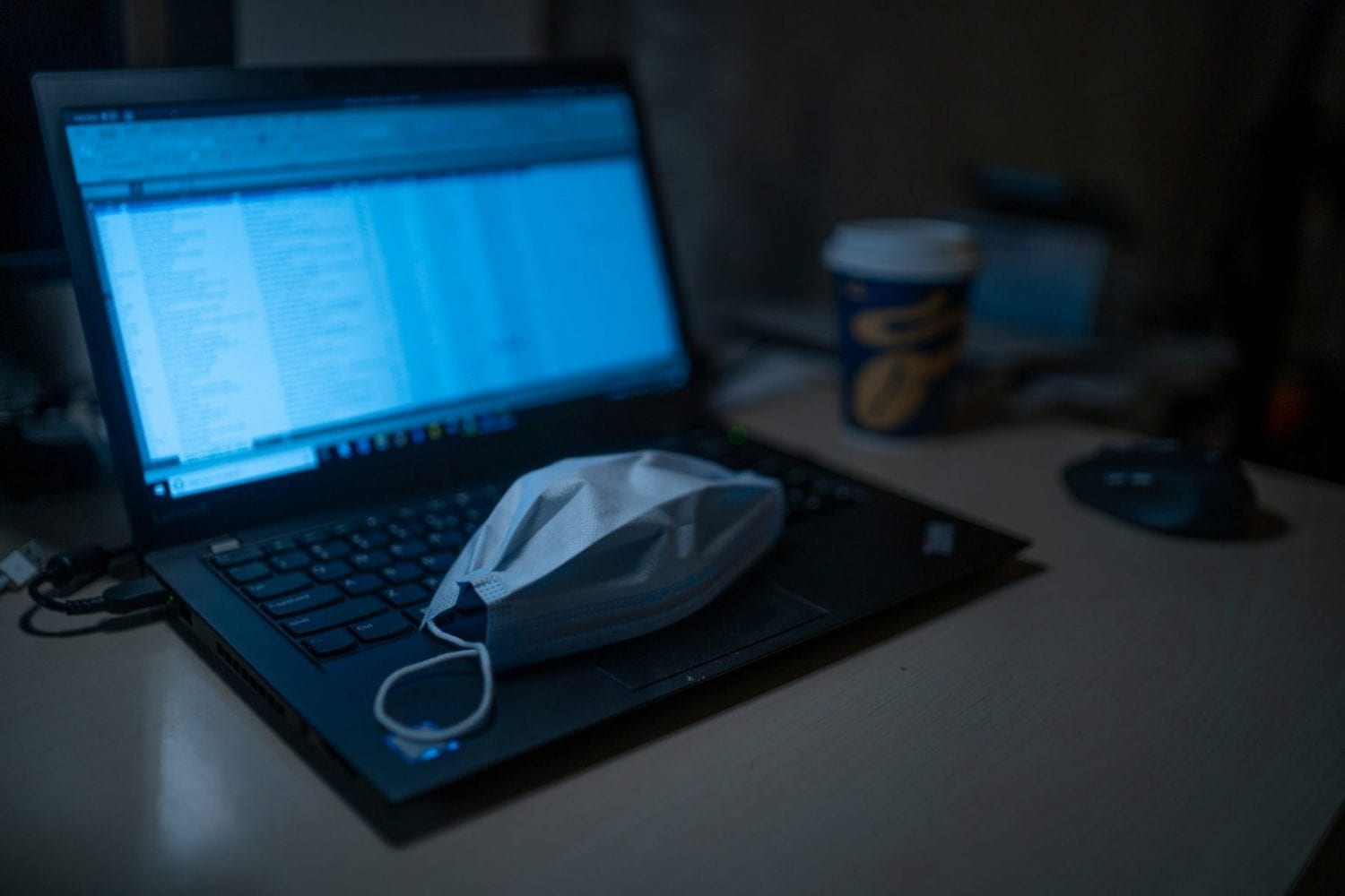A coronavirus Mask on a laptop keyboard